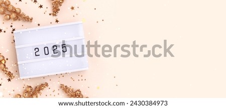 Banner with 2025 numbers, lightbox, golden stars confetti and decorative branches on a beige background. New Year concept.