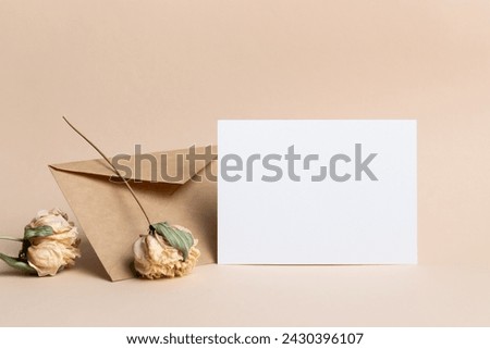 Blank wedding invitation or greeting card mockup with envelope and dry flowers