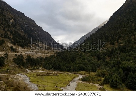 Landscape of the high mountain range at sela pass arunachal pradesh northeastern India.Beautiful scenery of snow capped mountains and snow on ground, deep blue water in small lake and blue sky. Royalty-Free Stock Photo #2430397871