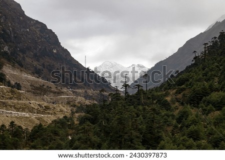 Landscape of the high mountain range at sela pass arunachal pradesh northeastern India.Beautiful scenery of snow capped mountains and snow on ground, deep blue water in small lake and blue sky. Royalty-Free Stock Photo #2430397873