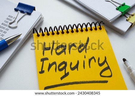 Yellow notepad with words hard inquiry and notepads. Royalty-Free Stock Photo #2430408345