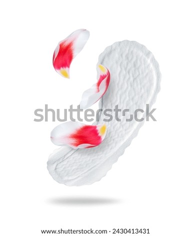 Women panty liner pad with red tulip petals closeup isolated on white background