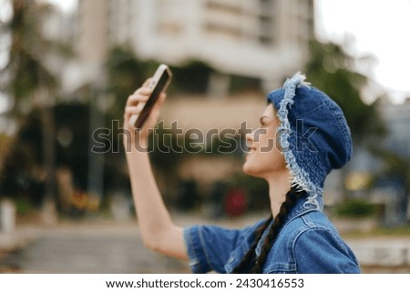 Beautiful Young Female Tourist Taking Selfie in Urban City Using Smartphone with Background of Summer Street
