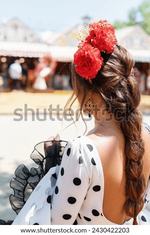 Seville, Spain - April 23, 2023 Beautiful woman wearing flamenco dress. April Fair Seville, Andalusia Royalty-Free Stock Photo #2430422203