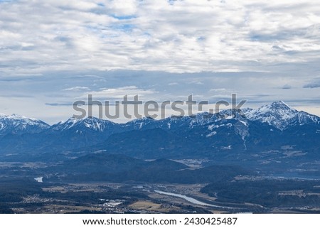 View from the Carinthian mountain Görlizen to the Karawanken ridge and Lake Ossiacher in winter Royalty-Free Stock Photo #2430425487