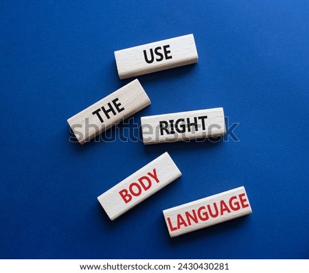 Use the right Body Language symbol. Concept words Use the right Body Language on wooden blocks. Beautiful deep blue background. Business concept. Copy space