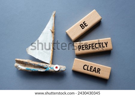 Be perfectly clear symbol. Concept words Be perfectly clear on wooden blocks. Beautiful grey background with boat. Business and Be perfectly clear concept. Copy space Royalty-Free Stock Photo #2430430345