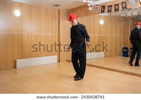 retired man giving dance classes at school