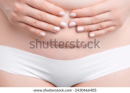 Woman belly with a scar from a cesarean section. Motherhood and childbirth 