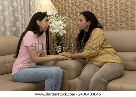 Caring mother talk comfort unhappy sad teenage daughter suffering from psychological problems, loving mom support make peace with depressed introvert grown up girl. Royalty-Free Stock Photo #2430483045