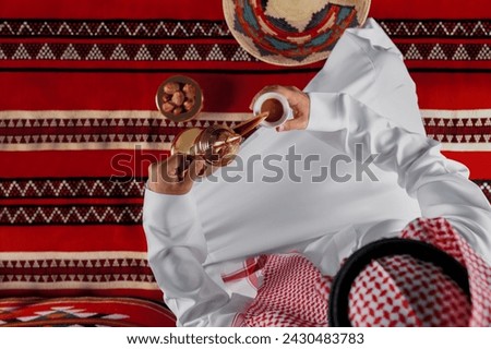 Arab Man serving traditional arabic coffee from a traditional pot.
Arab Man serving traditional arabic coffee from a traditional pot. Royalty-Free Stock Photo #2430483783