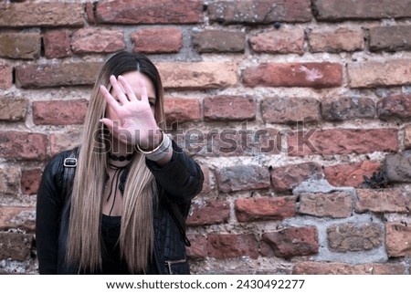 Pretty young girl making stop sign. Stop hand of woman sign of discrimination. Woman is showing stop gesture with her hand .