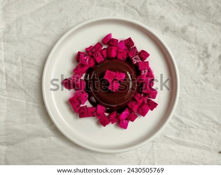 Chocolate pudding with pitaya or dragon fruit on a plate. Blurred background