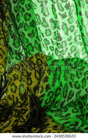 silk fabric green yellow with leopard print. Lightweight leopard print silk is perfect for your design, looks stylish and not vulgar! Texture, background, pattern