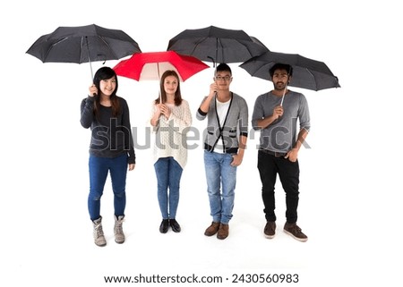 Unique woman holding a red umbrella unique, standing out from crowd of friends holiding black umbrellas. Isolated on a white background.