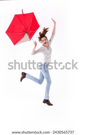 Full-length image of a Caucasian woman wearing casual clothes and standing under an umbrella. Isolated on White Background.