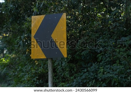A yellow sign with the title in road