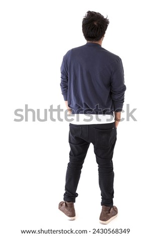 Backview of Indian man looking away.. Full-length image. Isolated on white background. Royalty-Free Stock Photo #2430568349