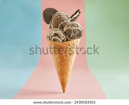 Indulge in a delightful ice cream cone with three chocolate scoops, white chocolate drizzle, and cookie crumbs. Perfect for summer treats. Isolated on a pastel background.
