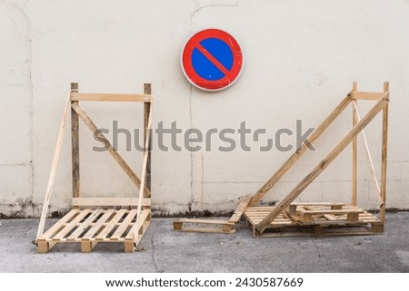 No parking sign. Pallet storage. Pallet storage on the sidewalk. industry and respect for traffic. Strange photo. Traffic Laws