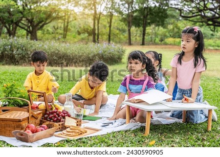 A little boy and girl were having fun drawing pictures, Group of children playing and on sunny summer day in the park,  holiday relaxation concept, picnic in summer park, outdoor education concepts