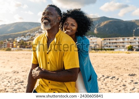 Beautiful mature black couple of lovers dating at the seaside - Married african middle-aged couple bonding and having fun outdoors, concepts about relationship, lifestyle and quality of life Royalty-Free Stock Photo #2430605841