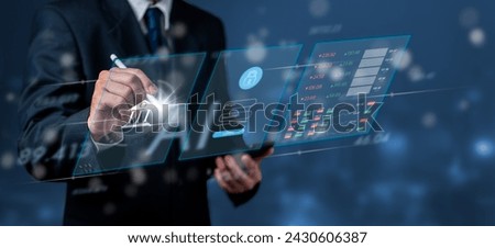 A businessperson interacts with a futuristic digital interface displaying bank security features. The image suggests advanced technology in financial security and data encryption. Royalty-Free Stock Photo #2430606387