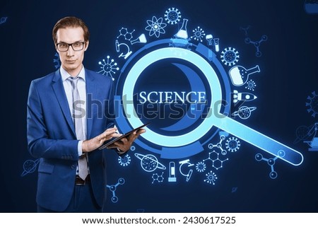 A professional man holding a digital tablet stands before a vibrant science-themed graphic with icons and the word SCIENCE