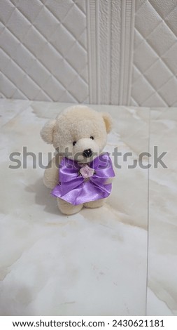 Small teddy bear with ribbon for wedding accessories