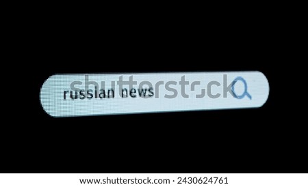 Shot of monitor screen. Pixel screen with animated search bar, keywords Russian news typed in, browser bar with magnifying glass and text headline.