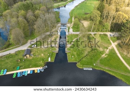 aerial view over dam lock sluice on lake impetuous waterfall Royalty-Free Stock Photo #2430634243