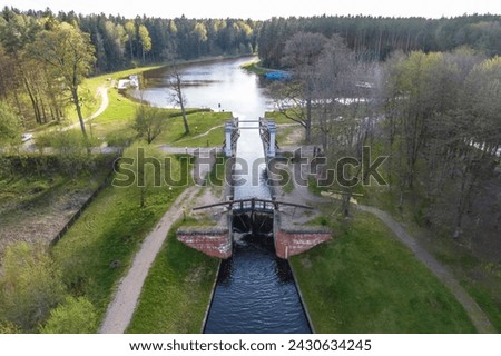 aerial view over dam lock sluice on lake impetuous waterfall Royalty-Free Stock Photo #2430634245