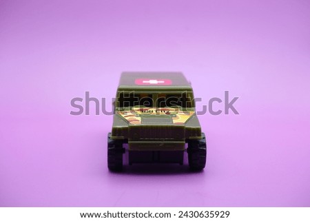 toy car isolated on purple background. imitation of an ambulance usually used by the armed forces.