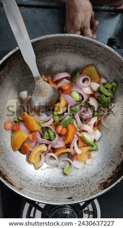 Picture of a person cooking vegetables in a cooking utensil