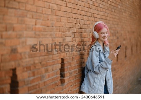 Woman in pink hair using smartphone on the street