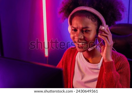 Host channel of gaming streamer, African girl wining with Esport skilled team player and viewers online game in neon color lighting room. Concept of cybersport indoor activities. Tastemaker.
