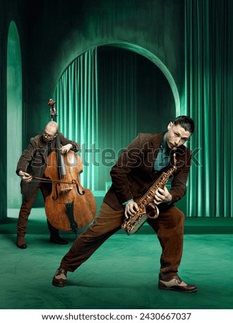 Two male musicians playing saxophone and double bass in green curtained room. Improvisation techniques in jazz music. Concept of music, performance, art, talent show, inspiration. Poster