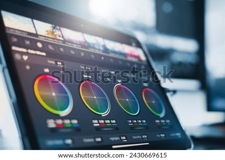 Close-up of a color wheel. filmmaker or colorist, working with footage on a digital tablet, in a creative office studio.