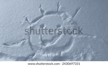The smiling sun is painted in the snow