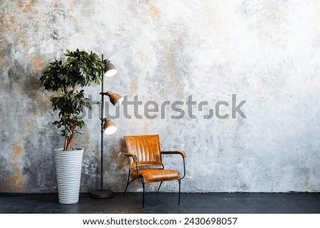 In the room, a wooden chair sits beside a window with a houseplant on the windowsill. A lamp illuminates the space, adding warmth to the tints and shades of the flooring Royalty-Free Stock Photo #2430698057