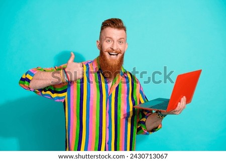 Photo of young project manager with few year experience make thumb up like using macbook pro isolated on aquamarine color background