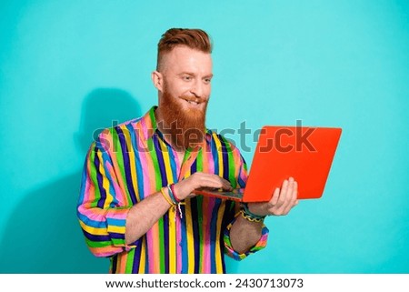 Photo of remote working professional it specialist coding his new app software for ehealth project isolated on cyan color background