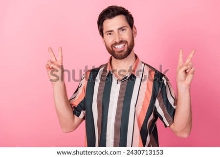 Portrait of satisfied glad young person toothy smile arms fingers demonstrate v-sign isolated on pink color background Royalty-Free Stock Photo #2430713153