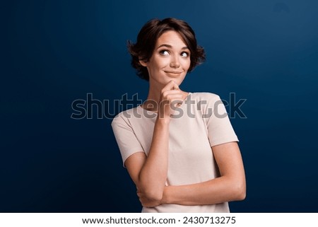 Portrait of pretty interested genius girl holding finger hand on her chin have idea look side isolated dark blue color background