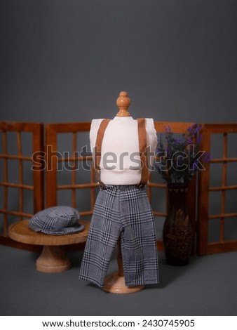 Selected focus photo of men's loungewear themed newborn photo costume with blurred background