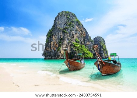 Thai traditional wooden longtail boat and beautiful sand Ao Phra Nang Beach in Krabi province. Ao Nang, Thailand. Travel summer concept. Royalty-Free Stock Photo #2430754591