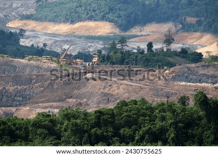 View of opencast mining quarry with lots of machinery at work. Coal mines in East Kalimantan, Indonesia Royalty-Free Stock Photo #2430755625
