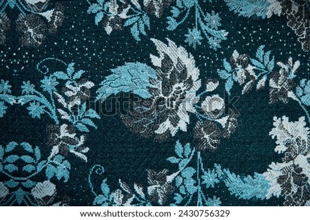 The texture of the old tapestry fabric is blue with a pattern