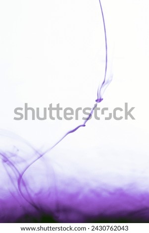 water soluble violet photo There are patterns created by the flow of paint in the water.