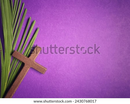 Holy Week, Lent, Palm Sunday, Good Friday, Easter Sunday Concept. Cross shaped and palm leaf in purple background with copy space. Royalty-Free Stock Photo #2430768017
